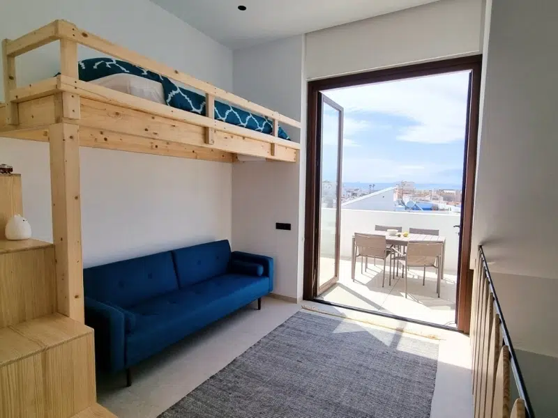 Living room with extra sofa bed on the mezzanine area