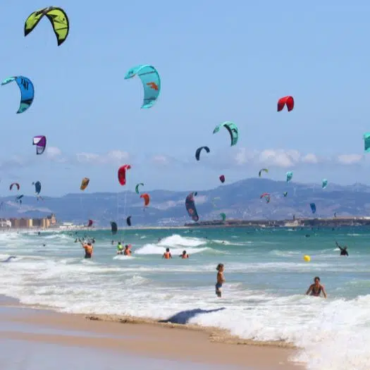 Tarifa beach crowded in Los Lances with a lot of kite.