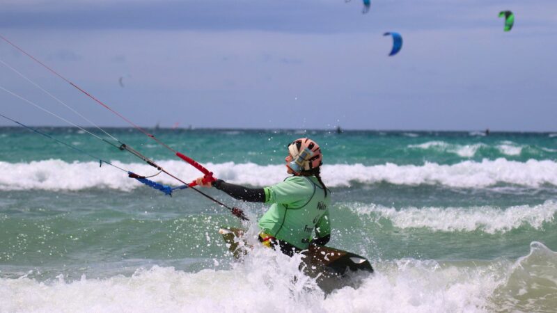 Beginner kitesurfing students practicing at Los Lances Norte, the safest training zone in Tarifa for IKO Level 1 and 2 courses.